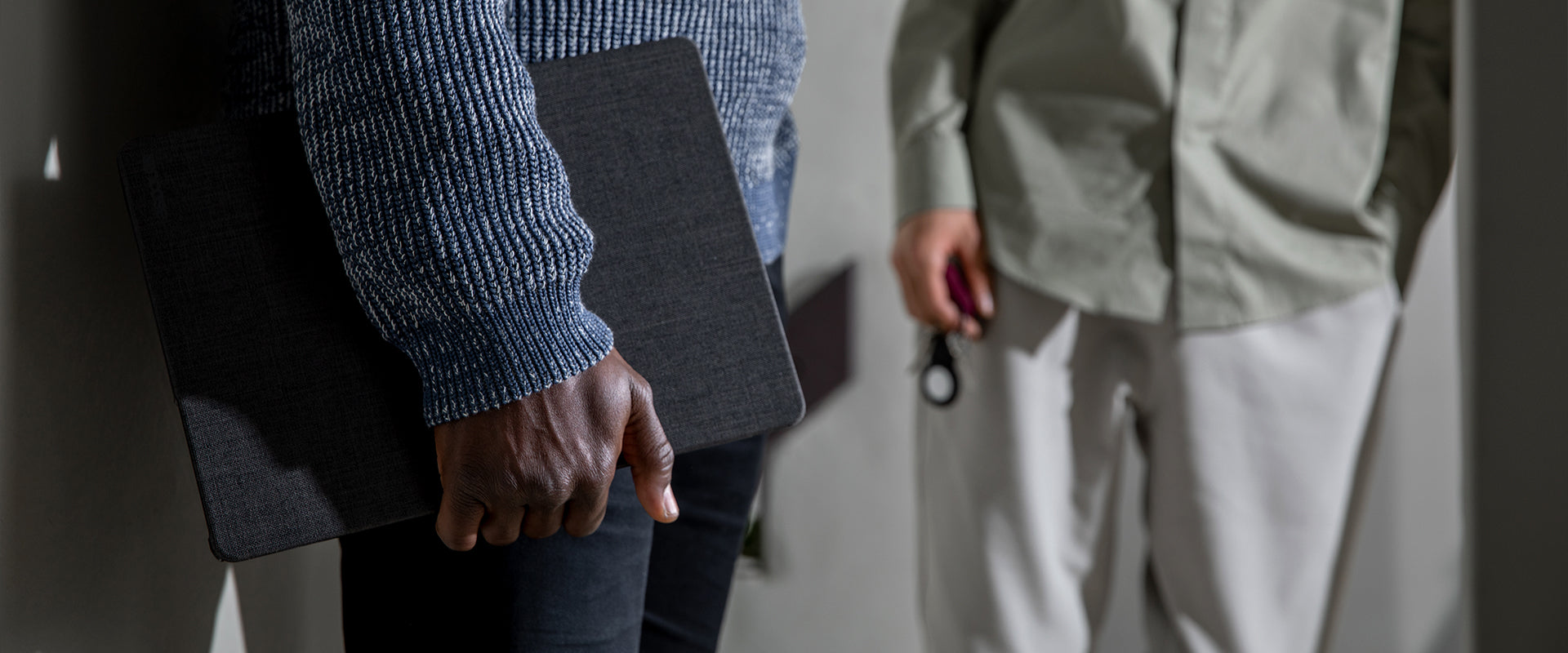 person holding macbook pro with an incase woolenex textured hardshell